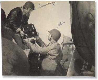 Off-loading a A-5 film magazine after a mission.  (Harold Vaughn)
